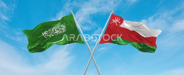 two crossed flags Oman and Saudi Arabia waving in wind at cloudy sky. Concept of relationship, dialog, travelling between two countries. 3d illustrati two crossed flags Oman and Saudi Arabia waving in wind at cloudy sky. Concept of relationship, dialog, travelling between two countries. 3d illustrati