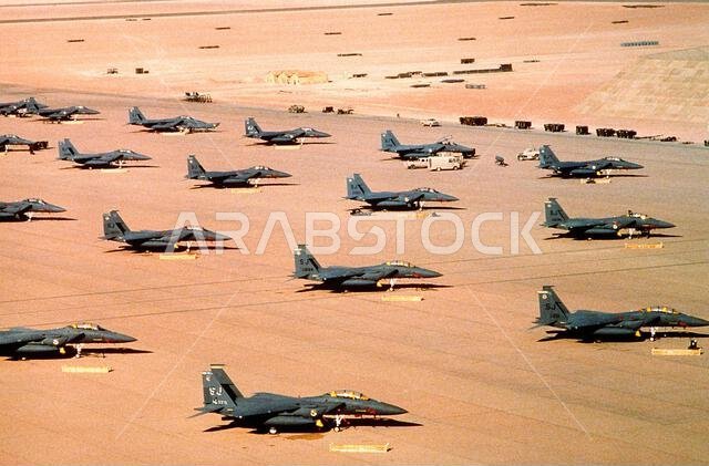 F-15E Eagle fighter aircraft of the 4th Tactical Fighter Wing, Seymour Johnson Air Force Base, N.C., are parked on an air field during Operation Desert Shield. Subject Operation/Series: DESERT SHIELD Country: Saudi Arabia (SAU)