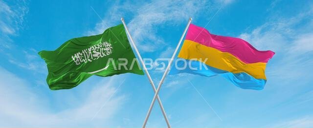 two crossed flags Pansexuality Pride and Saudi Arabia waving in wind at cloudy sky. Concept of relationship, dialog, travelling between two countries.