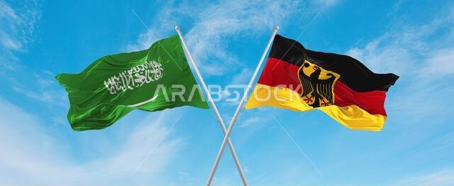 علمان متقاطعان، علم ألمانيا وعلم السعودية، يرفرفان في مهب الريح تحت سماء ملبدة بالغيوم. يرمز هذا العمل الفني إلى مفهوم العلاقة والحوار والسفر بين البلدين. رسم ثلاثي الأبعاد. علمان متقاطعان، علم ألمانيا وعلم السعودية، يرفرفان في مهب الريح تحت سماء ملبدة بالغيوم. يرمز هذا العمل الفني إلى مفهوم العلاقة والحوار والسفر بين البلدين. رسم ثلاثي الأبعاد.