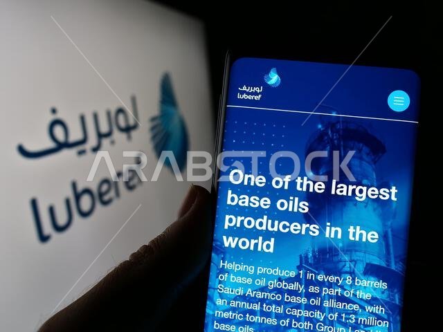 شخص يحمل هاتفًا محمولًا يعرض صفحة ويب لشركة لوبريف السعودية للزيوت الأساسية أمام الشعار. التركيز على منتصف شاشة الهاتف. شخص يحمل هاتفًا محمولًا يعرض صفحة ويب لشركة لوبريف السعودية للزيوت الأساسية أمام الشعار. التركيز على منتصف شاشة الهاتف.