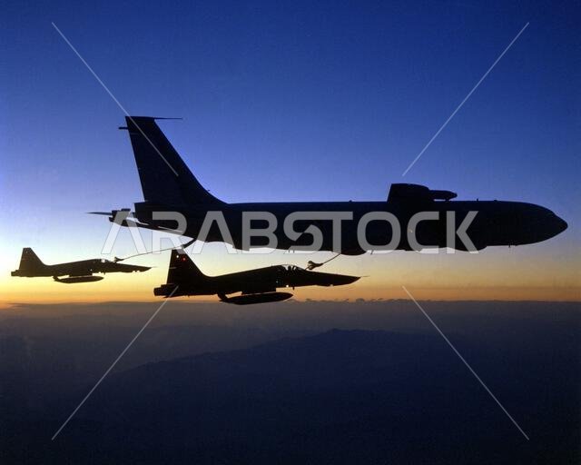 طائرات من طراز RF-5E Tiger II تابعة للقوات الجوية الملكية السعودية تتزود بالوقود من طائرة KC-135 Stratotanker عند غروب الشمس. البلد: غير معروف.