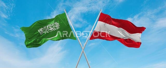 two crossed flags Austria and Saudi Arabia waving in wind at cloudy sky. Concept of relationship, dialog, travelling between two countries. 3d illustr