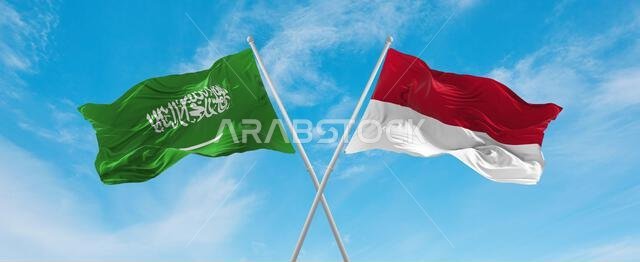 two crossed flags Indonesia and Saudi Arabia waving in wind at cloudy sky. Concept of relationship, dialog, travelling between two countries. 3d illus