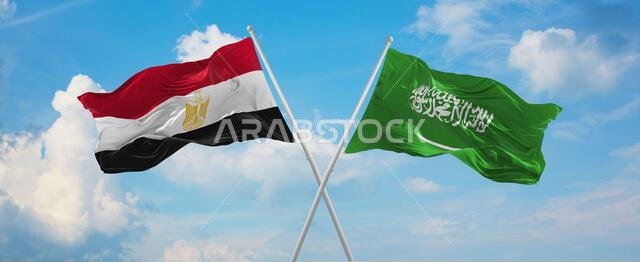 two crossed flags Saudi Arabia and Egypt waving in wind at cloudy sky. Concept of relationship, dialog, travelling between two countries. 3d illustrat