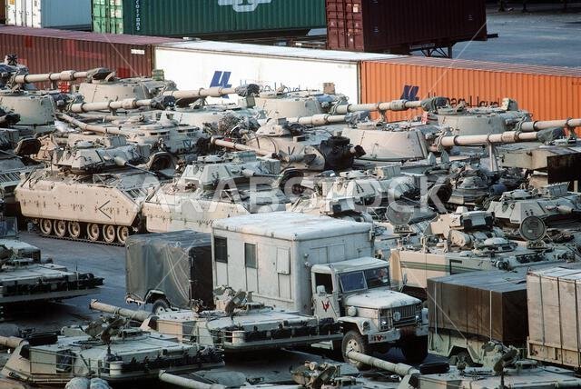 Tanks, armored personnel carriers and self-propelled howitzers of the 24th Infantry Division (Mechanized) line the pier in preparation for loading aboard rapid-response vehicle cargo ships. The equipment will be transported to Saudi Arabia in support of Operation Desert Shield. Subject Operation/Series: DESERT SHIELD Base: Savannah State: Georgia (GA) Country: United States Of America (USA)