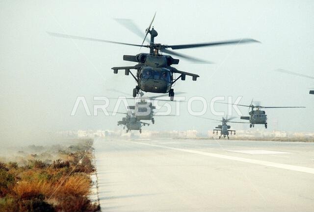 U.S. Army UH-60A Black Hawk (Blackhawk) helicopters and one AH-64A Apache helicopter, second from right, conduct a mass takeoff during Operation Desert Storm. Subject Operation/Series: DESERT SHIELD Country: Saudi Arabia (SAU)