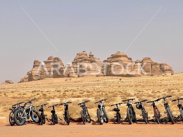 Several bikes with ruined rocky mountains in the desert of Al Ula, Saudi Arabia