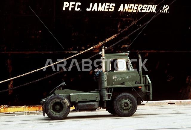 An M-878 tractor truck sits on the pier before being loaded aboard the maritime pre-positioning ship PFC. James Anderson Jr. (T-AK-3002). The ship will transport its cargo to Saudi Arabia in support of Operation Desert Shield. Subject Operation/Series: DESERT SHIELD Base: Newport News State: Virginia (VA) Country: United States Of America (USA) An M-878 tractor truck sits on the pier before being loaded aboard the maritime pre-positioning ship PFC. James Anderson Jr. (T-AK-3002). The ship will transport its cargo to Saudi Arabia in support of Operation Desert Shield. Subject Operation/Series: DESERT SHIELD Base: Newport News State: Virginia (VA) Country: United States Of America (USA)