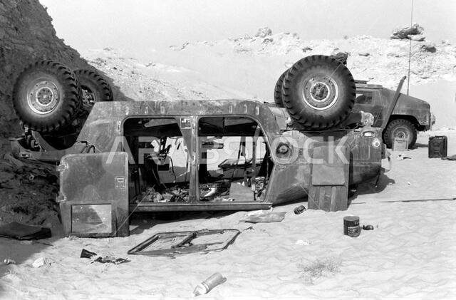 Side view overturned M998 High-Mobility Multipurpose Wheeled Vehicle (HMMWV). Country: Saudi Arabia (SAU) Side view overturned M998 High-Mobility Multipurpose Wheeled Vehicle (HMMWV). Country: Saudi Arabia (SAU)