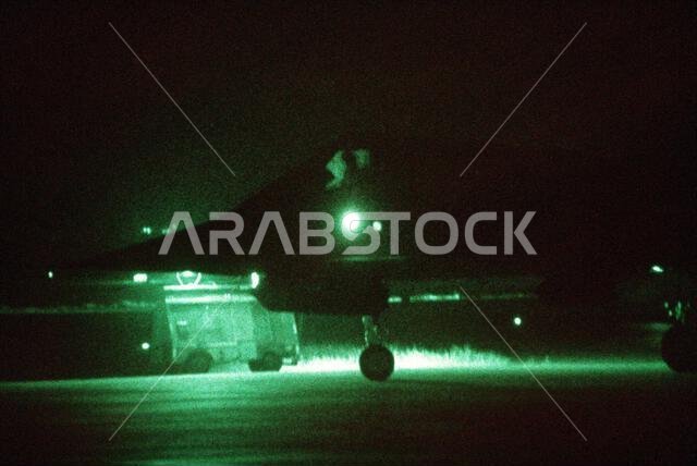 As seen through a night vision lens, an F-117A aircraft from the 37th Tactical Fighter Wing (37th TFW) taxis toward a runway during Operation Desert Shield. Subject Operation/Series: DESERT SHIELD Country: Saudi Arabia (SAU) As seen through a night vision lens, an F-117A aircraft from the 37th Tactical Fighter Wing (37th TFW) taxis toward a runway during Operation Desert Shield. Subject Operation/Series: DESERT SHIELD Country: Saudi Arabia (SAU)
