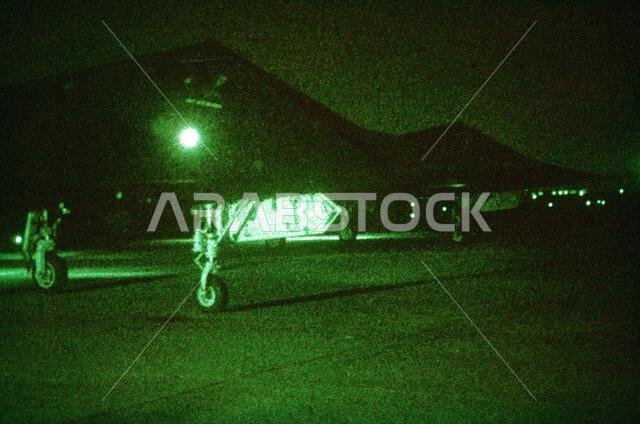 As seen through a night vision lens, two 37th Tactical Fighter Wing (37th TFW) F-117A aircraft sit on the flight line during Operation Desert Shield. Subject Operation/Series: DESERT SHIELD Country: Saudi Arabia (SAU) As seen through a night vision lens, two 37th Tactical Fighter Wing (37th TFW) F-117A aircraft sit on the flight line during Operation Desert Shield. Subject Operation/Series: DESERT SHIELD Country: Saudi Arabia (SAU)