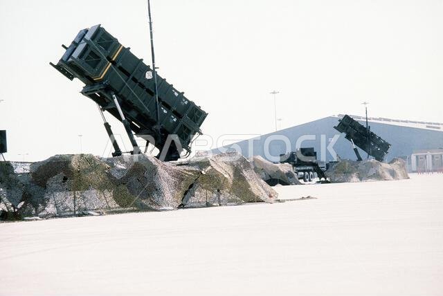 A partially camouflaged M-109 launching station for the MIM-104 Patriot missile stands ready for use during Operation Desert Shield. Subject Operation/Series: DESERT SHIELD Base: Jubail Country: Saudi Arabia (SAU)