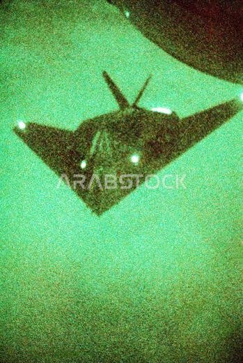As seen through a night vision lens, an F-117A aircraft from the 37th Tactical Fighter Wing (37th TFW) moves in for a midair refueling during Operation Desert Shield. Subject Operation/Series: DESERT SHIELD Country: Saudi Arabia (SAU)