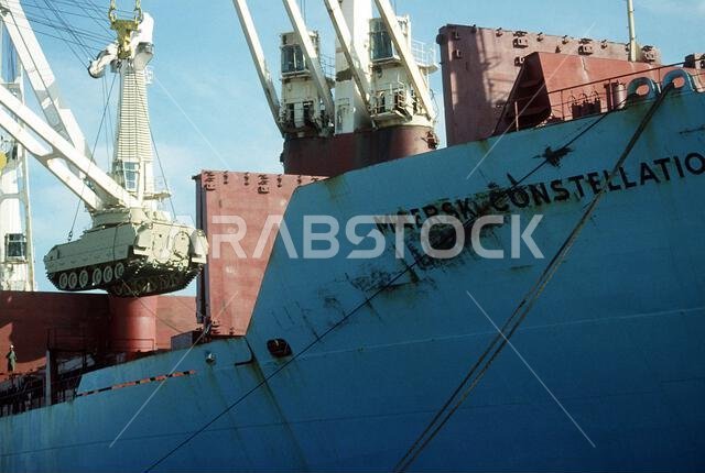 A crane on the Military Sealift Command-chartered vessel MAERSK CONSTELLATION lowers an M-2A2 Bradley infantry fighting vehicle to the pier as equipment is delivered during Operation Desert Shield. Subject Operation/Series: DESERT SHIELD Country: Saudi Arabia(SAU) A crane on the Military Sealift Command-chartered vessel MAERSK CONSTELLATION lowers an M-2A2 Bradley infantry fighting vehicle to the pier as equipment is delivered during Operation Desert Shield. Subject Operation/Series: DESERT SHIELD Country: Saudi Arabia(SAU)
