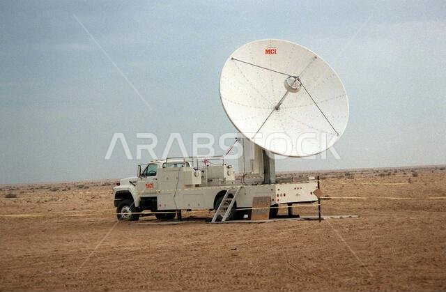 A view of an MCI, a long-distance telephone company, satellite communications vehicle. The vehicle has been set up at the 1ST Marine Division's Division Support Activity (DSA) site during Operation Desert Shield. Subject Operation/Series: DESERT SHIELD Country: Saudi Arabia (SAU)