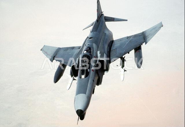 A 35th Tactical Fighter Wing F-4G Phantom II aircraft banks to the right while on a training flight during Operation Desert Shield. The aircraft is carrying external fuel tanks on its outboard wing pylons and AGM-88A HARM high-speed anti-radiation missiles on its inboard wing pylons. Subject Operation/Series: DESERT SHIELD Country: Saudi Arabia (SAU) A 35th Tactical Fighter Wing F-4G Phantom II aircraft banks to the right while on a training flight during Operation Desert Shield. The aircraft is carrying external fuel tanks on its outboard wing pylons and AGM-88A HARM high-speed anti-radiation missiles on its inboard wing pylons. Subject Operation/Series: DESERT SHIELD Country: Saudi Arabia (SAU)