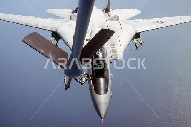 An F-14A Tomcat aircraft is refueled by a KC-135 Stratotanker aircraft during Operation Desert Shield. Subject Operation/Series: DESERT SHIELD Country: Saudi Arabia (SAU) An F-14A Tomcat aircraft is refueled by a KC-135 Stratotanker aircraft during Operation Desert Shield. Subject Operation/Series: DESERT SHIELD Country: Saudi Arabia (SAU)