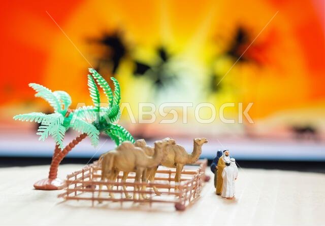 مفهوم لعبة مصغرة لرجل عربي وزوجته يرتديان العباءة ويشتريان جملاً وخروفاً من طفل في مزرعة.