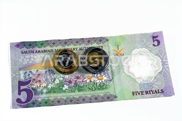 Reverse side of the new polymer 5 SAR five Saudi Arabia riyals cash money banknote bill series 1441 AH features a field of flowers with 1 and 2 riyals