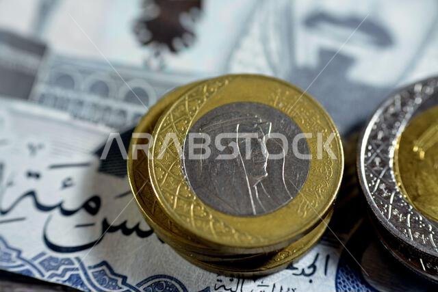 Saudi Arabia coins of 1, 2 SAR one and two Saudi Arabia riyals features king Salman and king AbdulAziz Al Saud isolated on 500 SAR riyals, Selective f