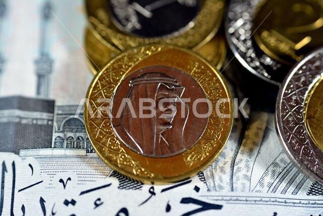 Obverse side of 1 SAR one Saudi Arabia riyals coin series 1438 AH 2016 features portrait of king Salman Bin AbdulAziz  Al Saud and Multiple Coat of Ar