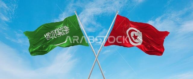 two crossed flags Tunisia and Saudi Arabia waving in wind at cloudy sky. Concept of relationship, dialog, travelling between two countries. 3d illustr