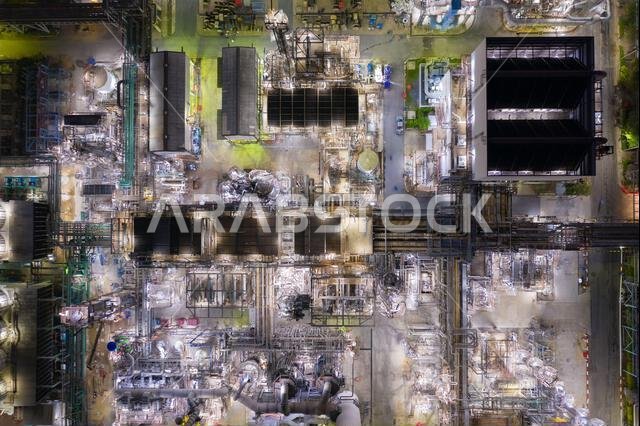 An aerial view of a Refinery factory oil storage tank and pipeline steel at night