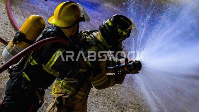 U.S. Air Force Senior Airman King Gentles, a firefighter with the 378th Expeditionary Civil Engineer Squadron, assisted by a Royal Saudi Air Force firefighter tests the pressure of a fire hose before training at Prince Sultan Air Base, Kingdom of Saudi Arabia, Aug. 24, 2022. The host nation integration firefighting and other partnership training help the USAF and RSAF forge a resolute partnership while showing potential regional aggressors PSAB’s capabilities and how together the sum is greater 