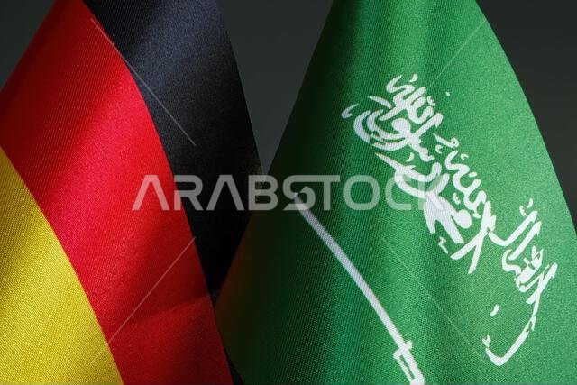 Close-up of small flags of Germany and Saudi Arabia.