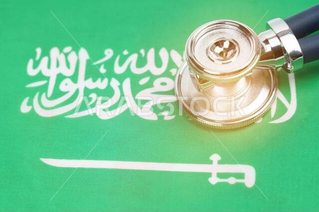 Medicine and economics concept. There is a stethoscope on the flag of Saudi Arabia.