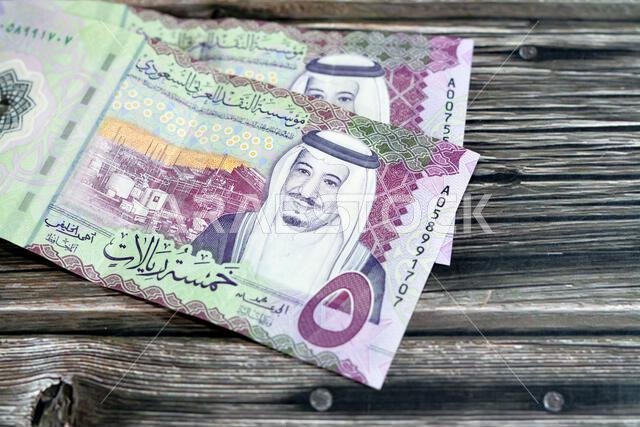 Obverse side of the new polymer 5 SAR five Saudi Arabia riyals cash money banknote bill series 1441 AH features Shaybah oil refinery in Rub' al Khali Obverse side of the new polymer 5 SAR five Saudi Arabia riyals cash money banknote bill series 1441 AH features Shaybah oil refinery in Rub' al Khali