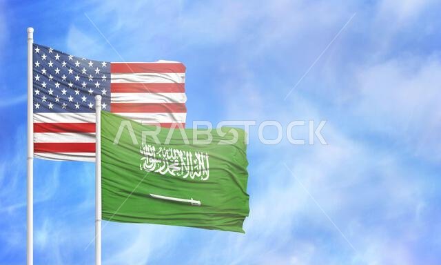 يلوحان بالعلم الأمريكي وعلم المملكة العربية السعودية.