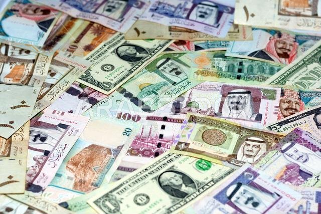 Saudi Arabia riyals money banknotes with American dollars banknotes money, selective focus of Saudi Arabia money riyals, United States of America doll