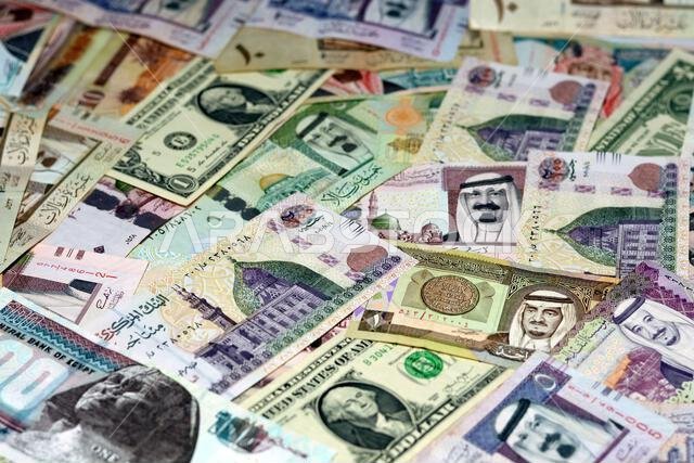 American dollars and Egyptian pounds banknotes money with Saudi Arabia riyals money banknotes, selective focus of Saudi Arabia money riyals, USA dolla American dollars and Egyptian pounds banknotes money with Saudi Arabia riyals money banknotes, selective focus of Saudi Arabia money riyals, USA dolla