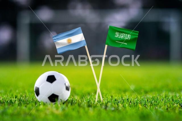 Argentina vs. Saudi Arabia, Lusail,, Football match wallpaper, Handmade national flags and soccer ball on green grass. Football stadium in background.