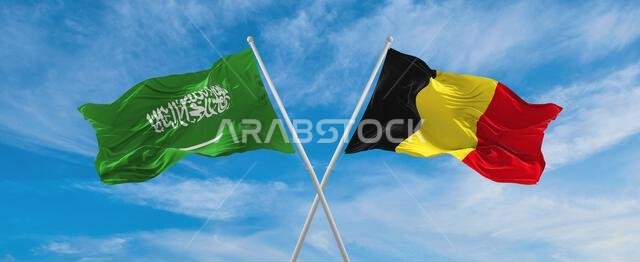 two crossed flags Saudi Arabia and Belgium waving in wind at cloudy sky. Concept of relationship, dialog, travelling between two countries. 3d illustr