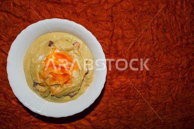 Turkish or Arabic food cuisine Hummus or Humus served in bowl. Hummud dip garnished with red chilly paprika and olive oil served in white bowl with da Turkish or Arabic food cuisine Hummus or Humus served in bowl. Hummud dip garnished with red chilly paprika and olive oil served in white bowl with da