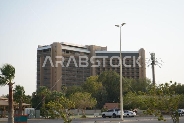 blue sky tall building, with some palm trees and windy weather. Saudi Arabia, Khobar, 10, June 2022.