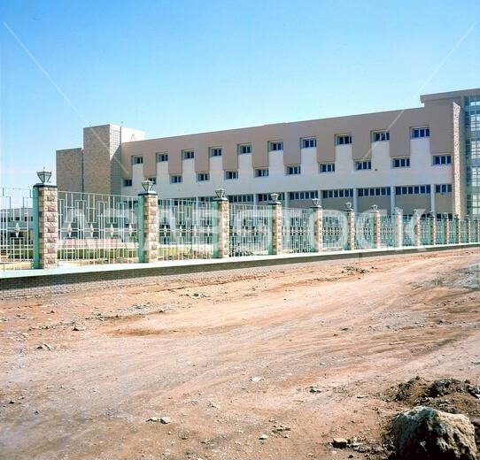 صورة تاريخية من ستينيات القرن العشرين، تُظهر الواجهة الخارجية لكلية الصيدلة الجديدة في جامعة الرياض بالمملكة العربية السعودية. تأسست جامعة الرياض عام ١٩٥٧ بأمر من الملك سعود بن عبد العزيز، وكانت أول جامعة في المملكة، وقد أُنشئت بموجب مرسوم ملكي لتوفير التعليم العالي والتدريب المهني لشبابها. وفي عام ١٩٨١، أُعيد تسميتها إلى جامعة الملك سعود (KSU) نسبةً إلى مؤسسها.