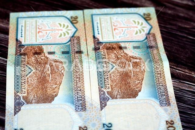 يُظهر الوجه الخلفي للورقة النقدية السعودية فئة 20 ريالاً جبل النور، وهو جبل يقع بالقرب من مكة المكرمة في منطقة الحجاز.