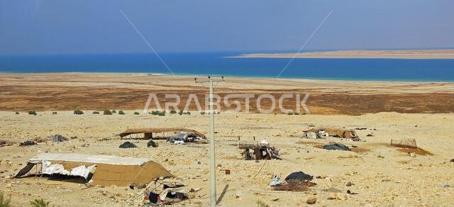 Village huts of a nomad camp in the desert near the sea in the Middle East in summer without people
