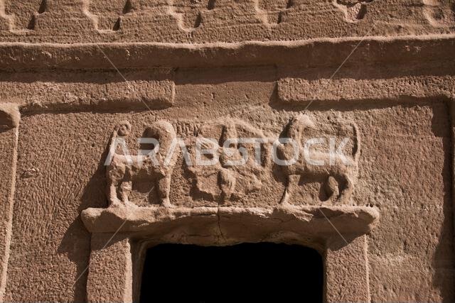 Close up two skilfully carved lion figures above tomb entrance Jabal At Banat Hegra Saudi Arabia Close up two skilfully carved lion figures above tomb entrance Jabal At Banat Hegra Saudi Arabia