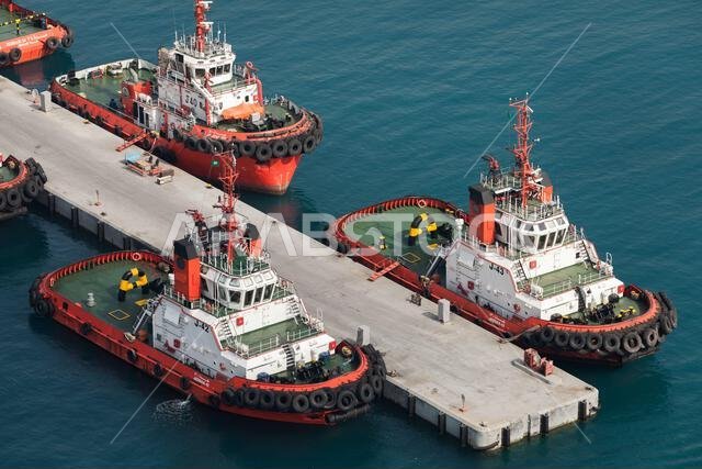 Jeddah, Saudi Arabia - December 22, 2019: Tug boats are moored in port. Aerial view Jeddah, Saudi Arabia - December 22, 2019: Tug boats are moored in port. Aerial view