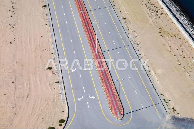 Empty asphalt road, aerial view on a sunny day Empty asphalt road, aerial view on a sunny day