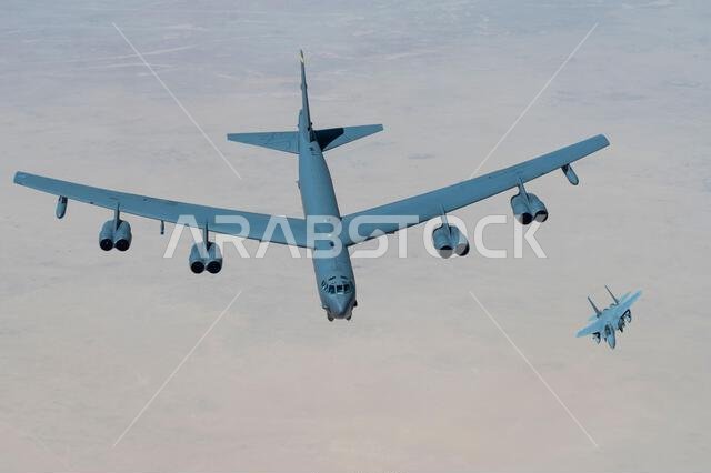A Royal Saudi Air Force F-15 flies with a U.S. Air Force B-52H Stratofortress above the Kingdom of Saudi Arabia, March 29, 2022. The bomber’s flight originated at Royal Air Force Fairford, England, and flew over the East Mediterranean, Arabian Peninsula, and Red Sea before departing the region. (U.S. Air Force photo by Staff Sgt. Joseph Pick)
