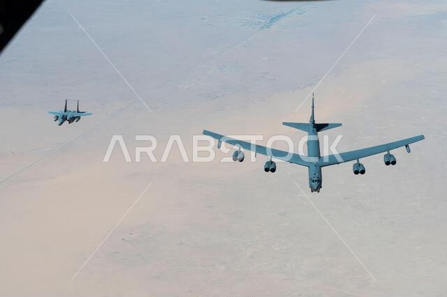 A Royal Saudi Air Force F-15 flies alongside a U.S. Air Force B-52H Stratofortress above the Kingdom of Saudi Arabia, March 29, 2022. The presence of the B-52H showcases U.S. Central Command's ability to deliver combat airpower at a moment's notice, as well as its commitment to partners and regional security. (U.S. Air Force photo by Staff Sgt. Joseph Pick) A Royal Saudi Air Force F-15 flies alongside a U.S. Air Force B-52H Stratofortress above the Kingdom of Saudi Arabia, March 29, 2022. The presence of the B-52H showcases U.S. Central Command's ability to deliver combat airpower at a moment's notice, as well as its commitment to partners and regional security. (U.S. Air Force photo by Staff Sgt. Joseph Pick)