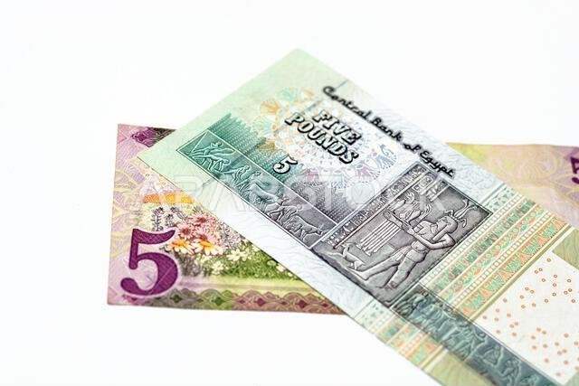 Reverse sides of Saudi Arabia 5 five riyals banknote with 5 LE five Egyptian pounds bill isolated on a white background, Selective focus of Egyptian a Reverse sides of Saudi Arabia 5 five riyals banknote with 5 LE five Egyptian pounds bill isolated on a white background, Selective focus of Egyptian a