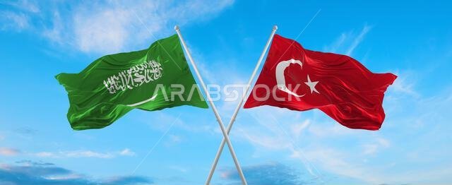 علمان متقاطعان، علم السعودية وعلم تركيا، يرفرفان في مهب الريح تحت سماء ملبدة بالغيوم. يرمز هذا العمل الفني إلى مفهوم العلاقة والحوار والسفر بين البلدين. رسم ثلاثي الأبعاد. علمان متقاطعان، علم السعودية وعلم تركيا، يرفرفان في مهب الريح تحت سماء ملبدة بالغيوم. يرمز هذا العمل الفني إلى مفهوم العلاقة والحوار والسفر بين البلدين. رسم ثلاثي الأبعاد.