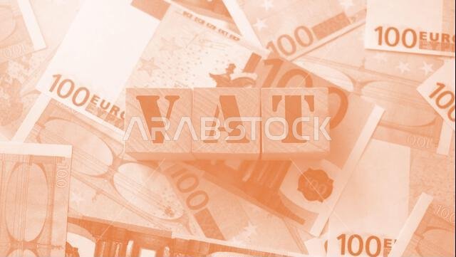VAT on wooden alphabet cubes with 100 euro banknotes around. Selective focus . Taxes and fees financial concept.
